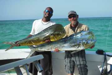 two men holding fish in punta cana